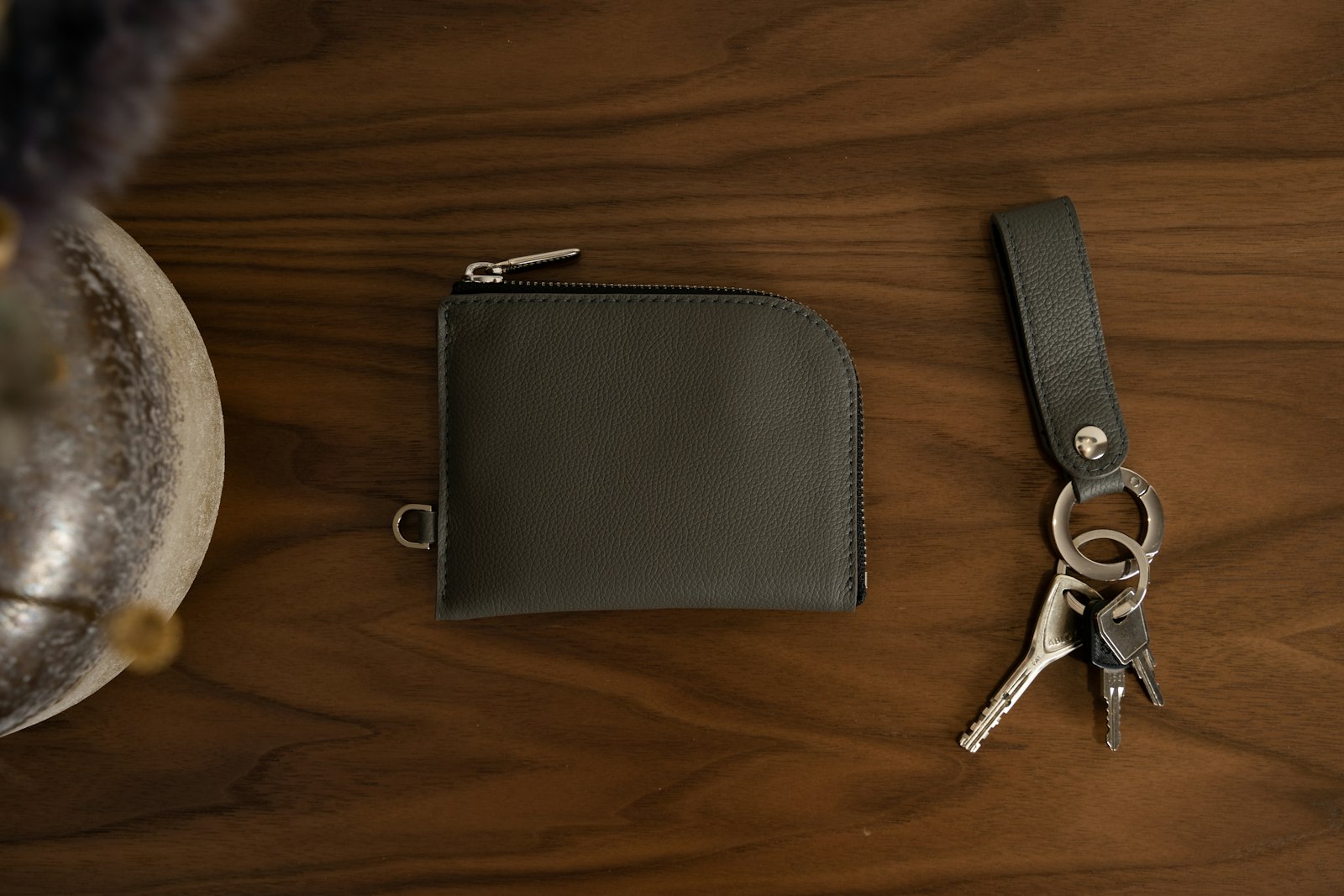 Leather wallet and keychain on a wooden table